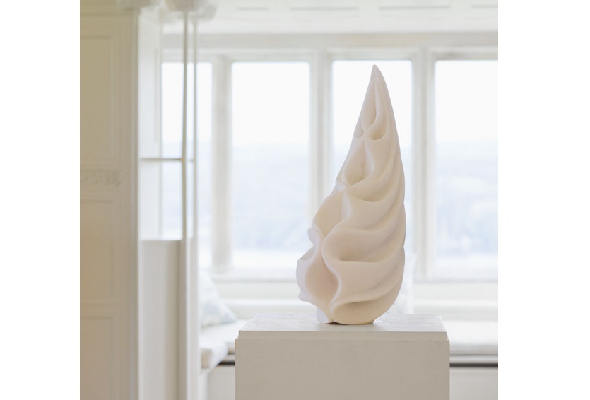 white tear shaped sculpture in front of window 