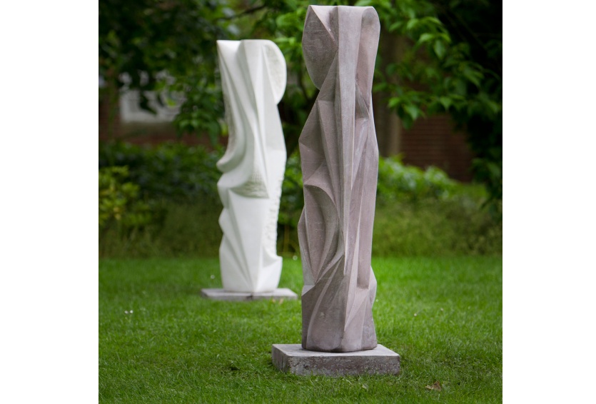 two large standing sculptures in garden