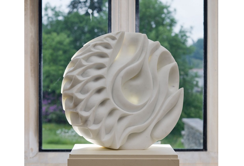 White sculpture in front of window
